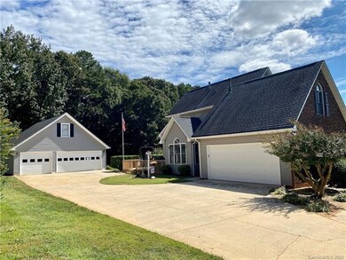 RARE! 2 car attached + 3 car detached garage with parking pad!