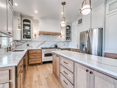 Kitchen featuring tasteful backsplash, a sink, lig
