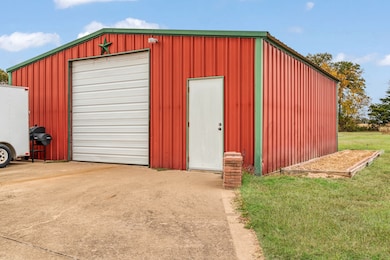 View of outbuilding with driveway