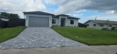 View of front facade with decorative driveway, stu