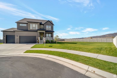 View of front of property featuring concrete driveway and an attached garage