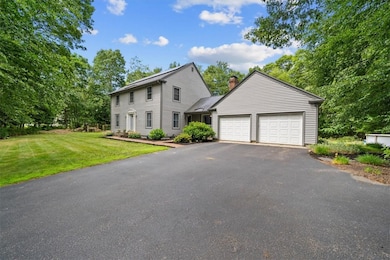 Wide paved driveway w/ two additional parking spot