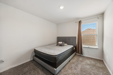 Carpeted bedroom featuring baseboards