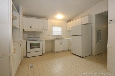 Light, bright kitchen, opening to living area. Ref