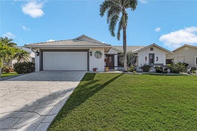 Ranch-style home with a tiled roof, a garage, driv