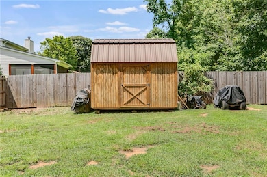View of shed featuring a fenced backyard
