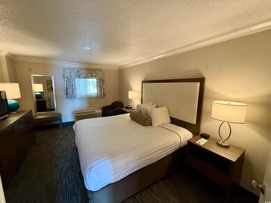 Bedroom with a textured ceiling and crown molding