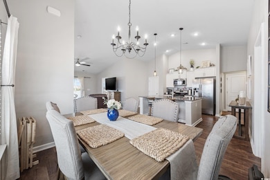 Dining space featuring ceiling fan, a chandelier, 