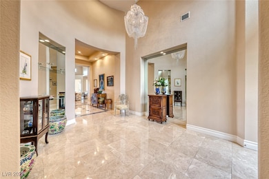 Entryway featuring visible vents, a towering ceili