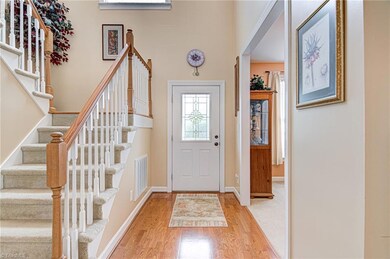 From the front door, you enter the two story foyer with hardwood floors.  Doorway to the right leads into the dining room and stairs to the left lead to master bedroom and two bedrooms.