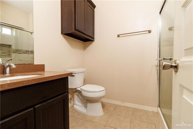 Full bathroom featuring a shower stall, vanity, and light tile patterned floors