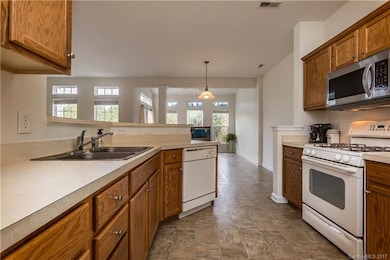 Spacious kitchen opens to dining area, sunroom and