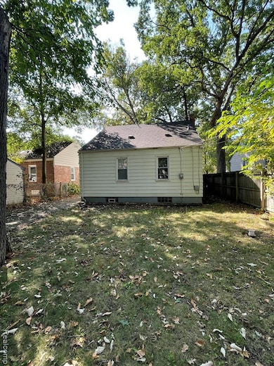 Back of property with a fenced backyard