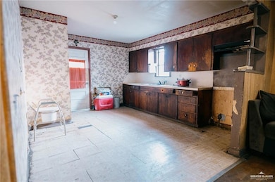 Kitchen with dark brown cabinetry