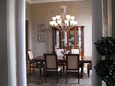 Formal Dining Room accented with columns and soari