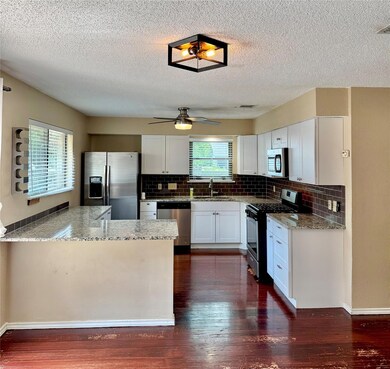 Kitchen featuring stainless steel appliances, lig