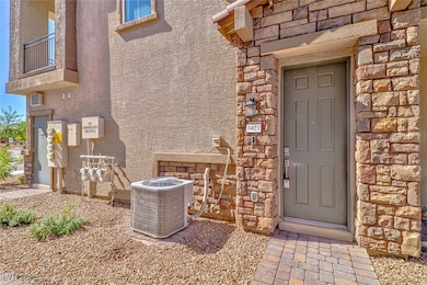 Property entrance featuring stone siding and stucco siding