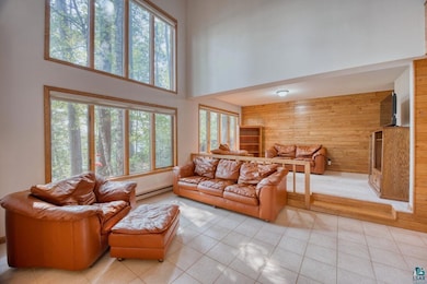 Tiled living room featuring a towering ceiling, a 