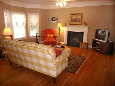 Another view of the great room with fireplace and lovely bay window.