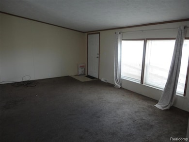 Empty room with ornamental molding and carpet