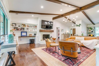 Living room with a notable chandelier, a brick fir