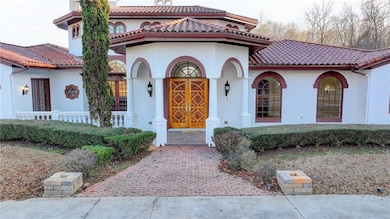 Mediterranean / spanish-style home with stucco siding and a tiled roof