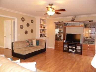 Greatroom with crown molding, speakers to add surr