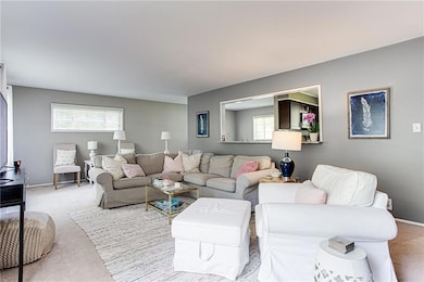 Carpeted living area with baseboards
