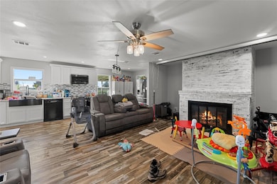 Living room featuring a fireplace, a healthy amoun