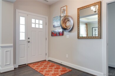 Entry foyer with pretty front door with sidelights
