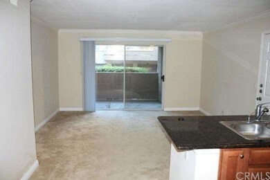 THE SPACIOUS LIVING ROOM IS OPEN TO THE KITCHEN AR