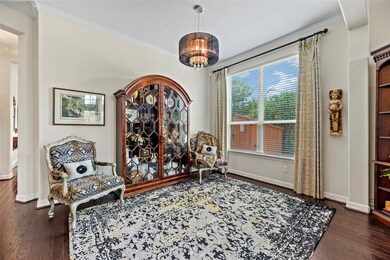 This is a well-lit formal dining room near the entryway that features room for your dining room or other multipurpose needs.  The room is highlighted by hardwood floors and a design light fixture.  Large windows allowing for ample natural light.