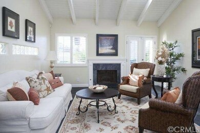 Living room with fireplace and french doors to pat
