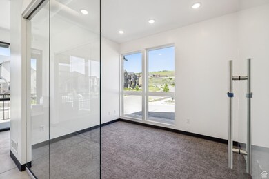 Spare room featuring dark carpet and recessed lighting