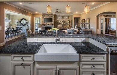 actual home has flat island and no farmhouse sink.
