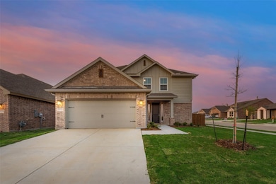 Craftsman house featuring board and batten siding, concrete driveway, a front lawn, brick siding, and a garage