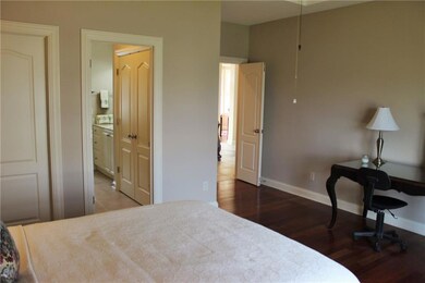 This view of bedroom two shows the walk in closet to the left of the photo, the entrance to the jack-n-jill bath and large closet in the bathroom and the French doors to enter into this room.