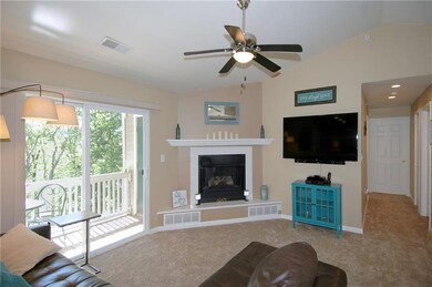 A corner gas log fireplace, paddle fan, cathedral 