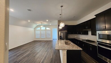 Kitchen with stainless steel appliances, a sink, 