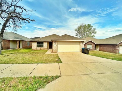 Ranch-style home with brick siding, a front yard, 