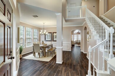 Upon entering, you're immediately drawn to the layout and the grand ceilings.  The beautiful wood tile floors, crisp and clean white stair railings, and pristine wall paint also draw you right in.