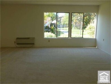 Living room with new carpet, fresh paint & view of