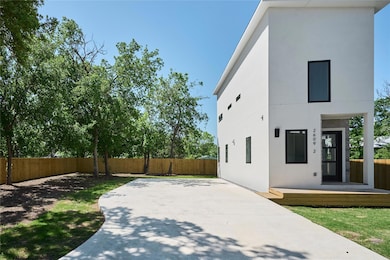 Rear view of house with a patio area, a fenced ba