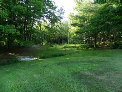 lush lawn and wooded 5 acre lot