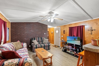 Living room with wood finished floors, ceiling fan