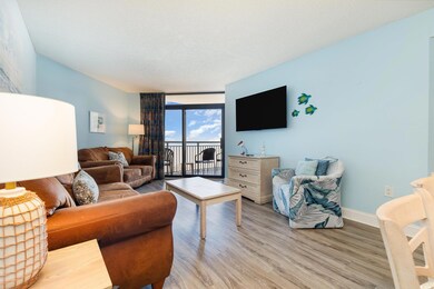 Living room with floor to ceiling windows, light h