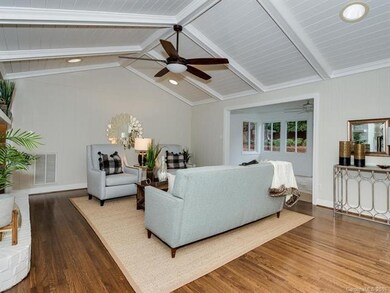 Light floods in from the window walled sunroom to 