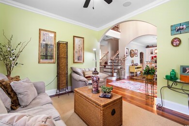Living room with ornamental molding, light wood-ty