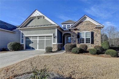Craftsman-style house with an attached garage, sto