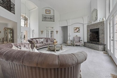 Living room with a stone fireplace, french doors,